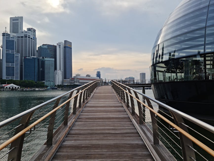 Explore the stunning skyline of Singapore from a wooden pier with modern architecture and skyscrapers.